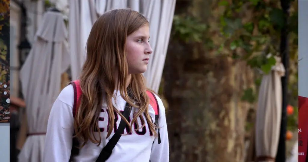Petite fille avec un sac àdos regardant au loin